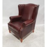 20th century brown leather wing-back office armchair on tapering supports