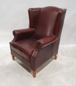 20th century brown leather wing-back office armchair on tapering supports