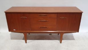 Mid century modern teak sideboard with three drawers, flanked by cupboard door, on tapering