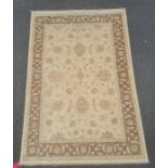 Modern rug, the central field decorated with stylised flowerheads on a cream ground, within a