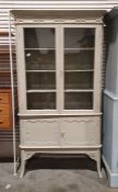 Early 20th century painted cabinet, the moulded cornice above two doors enclosing shelves, the