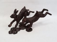 Modern bronze-effect metal sculpture / statue group of two leaping hares / rabbits, approx 52cm long