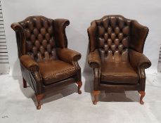 Two similar brown leather buttonback wing back armchairs, each on cabriole legs (2)  Condition