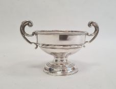 Silver two-handled pedestal bowl by J Boseck & Co, Birmingham 1911, of circular form with scroll