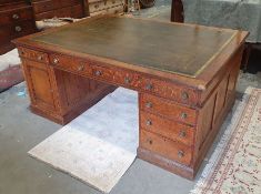 Edwardian oak partner's pedestal desk of large proportions, the rectangular gilt tooled leather