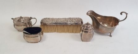 George V silver sauceboat of revived Georgian style, having open C-scroll handle, reeded rim and