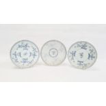 Pair of blue and white plates each decorated with trailing blossom with diaper borders, 22cm