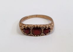 9ct gold, garnet and tiny diamond ring, set three facet-cut graduated oblong stones alternating with