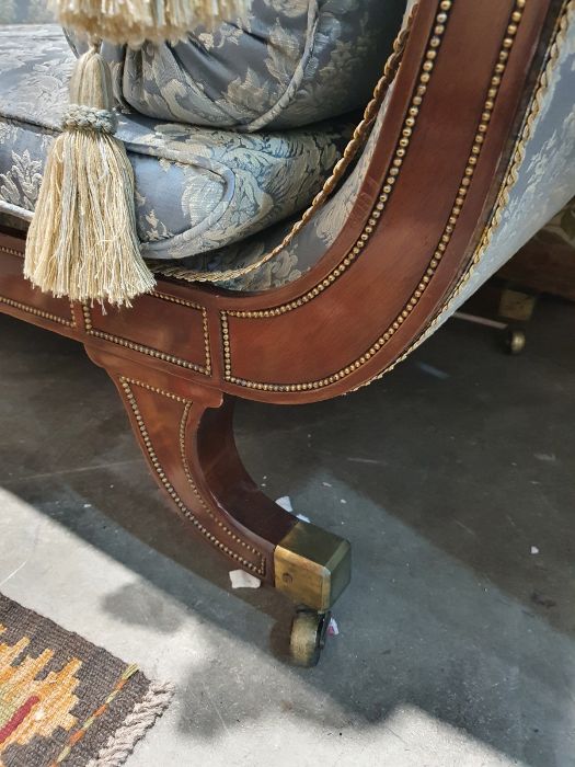 Regency sofa in blue ground foliate upholstery, outswept legs with brass caps and castors  Condition - Image 3 of 16