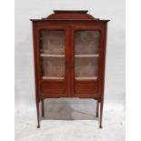 Early 20th century mahogany display cabinet with twin glazed doors enclosing shelves, tapering