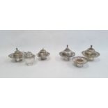 Six various engraved and shaped silver-coloured bowls and cups and five various domed covers, all