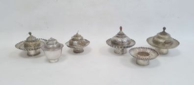 Six various engraved and shaped silver-coloured bowls and cups and five various domed covers, all
