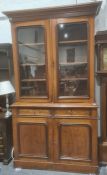 Late 19th/early 20th century bookcase cupboard with ogee moulded corners above two glazed doors