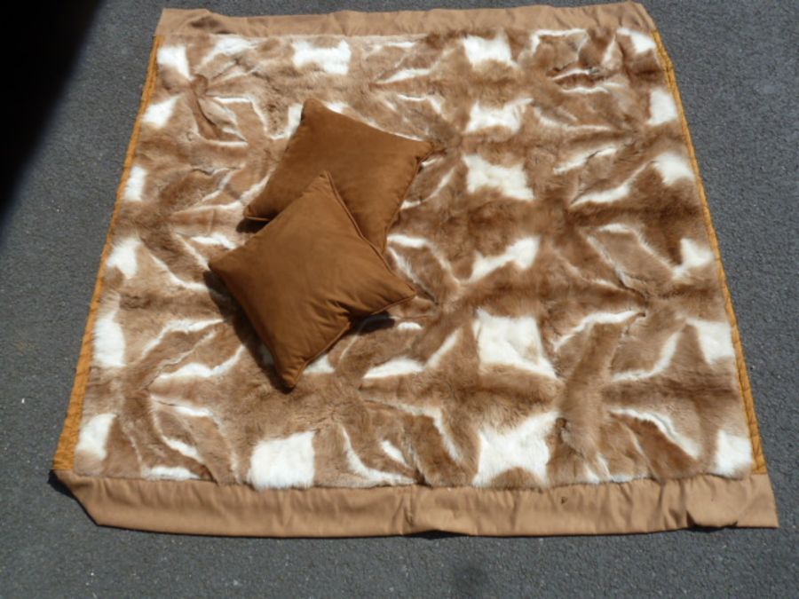 A (Llama) Guanaco throw, backed by gold coloured satin, labelled Hockley, 231 x 241 cms  and two