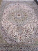 Turkish wool rug in cream, green and red, with floral decoration to centre, 197cm x 300cm