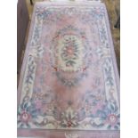 Chinese wool rug, pink ground with floral decoration, 162cm x 92cm