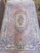 Chinese wool rug, pink ground with floral decoration, 162cm x 92cm