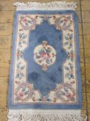 Three Chinese wool rugs in blue, pink and cream ground, floral decorated, 97cm x 62cm, 100cm x
