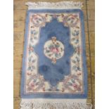 Three Chinese wool rugs in blue, pink and cream ground, floral decorated, 97cm x 62cm, 100cm x