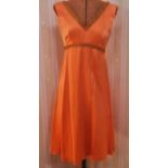 Vintage orange satin cocktail dress trimmed with gold and orange braid, five other 1980's-style