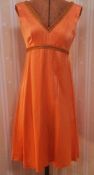 Vintage orange satin cocktail dress trimmed with gold and orange braid, five other 1980's-style