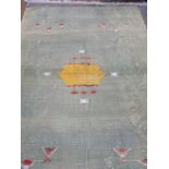 Large green with yellow and pink detail kelim-style rug throw (faded and with some damage) 272 x 170
