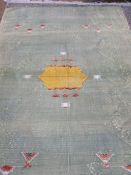 Large green with yellow and pink detail kelim-style rug throw (faded and with some damage) 272 x 170