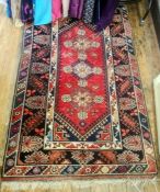 Persian-style wool rug in red, black, blue and cream, 192cm x 118cm
