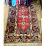 Persian-style wool rug in red, black, blue and cream, 192cm x 118cm