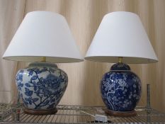 Chinese-style blue and white vase table lamp, on circular wooden base with cream shade and another