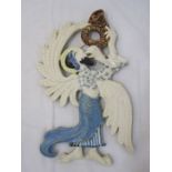 Painted ceramic plaque of an angel playing a trumpet, 44cm high