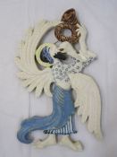 Painted ceramic plaque of an angel playing a trumpet, 44cm high