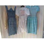 Three various child's dresses, circa 1950's with smocking and embroidered detail, a child's romper