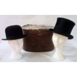 Black top hat labelled Dingley & Son, Hatters, Sherborne, with a black bowler, labelled inside, size