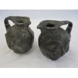 Two lead grinning mask ewers in the manner of the Martin brothers  16cm high (2)  Condition