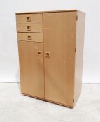 A 20th century light wood small compactum/wardrobe comprising of three small drawers and two