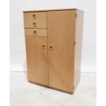 A 20th century light wood small compactum/wardrobe comprising of three small drawers and two