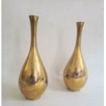 Pair of brass vases of baluster form, decorated with storks in water, 25cm high (2)