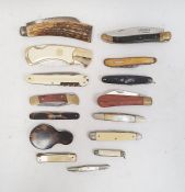 Quantity of penknives including a silver example, corkscrews, tools and other folding utensils