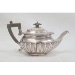 A Victorian silver teapot, ebony handle and finial, semi gadrooned, initialled 'R' , Edinburgh 1883,