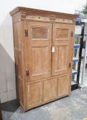 Late 19th/ early 20th century pine two door cupboard moulded cornice above the two panelled doors