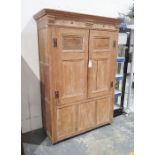 Late 19th/ early 20th century pine two door cupboard moulded cornice above the two panelled doors