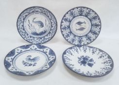 Four modern Spanish blue and white dishes decorated with birds, fish and flowers, within stylised