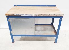 Modern workbench with single steel cupboard door,