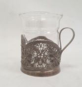 Silver-coloured metal filigree cup holder, flower decorated, with marks to base and a glass cup (not