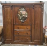 19th century wardrobe, oval mirrored central door over three drawers flanked by wardrobe doors on