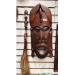 Carved African hardwood mask and a carved fly whisk, 49cm long
