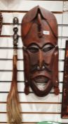 Carved African hardwood mask and a carved fly whisk, 49cm long