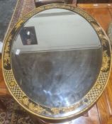 Oval bevel edged mirror in chinoiserie black ground frame with various figures together with one