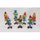 Murano glass clown playing an instrument, with blue hat, 29cm high and six others (7)